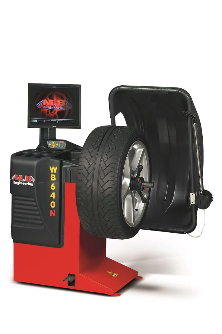 Technician performing wheel alignment and balancing on a car for smoother driving and improved tyre life